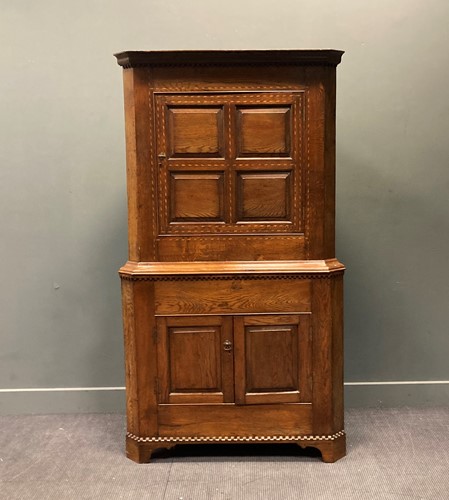 Lot 403 - A George III inlaid oak floor standing corner...