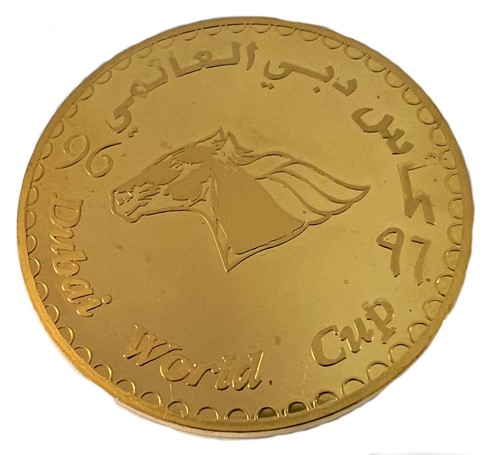 Lot 283 - A Dubai metalwares coin commemorating the inaugural Dubai World Cup horse race & shopping festival