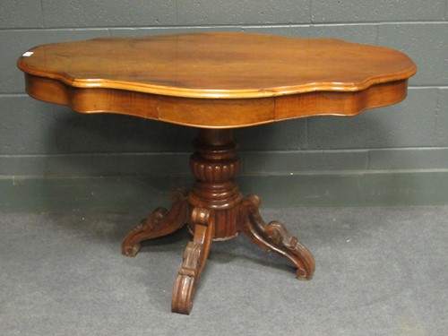 Lot 454 - A continental fruit wood centre table on...