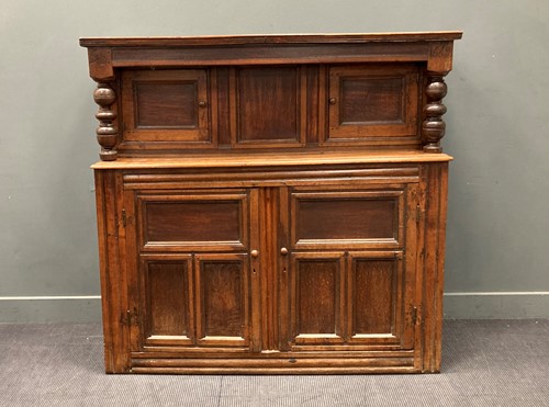Lot 389 - A 17th century and later oak panelled court...