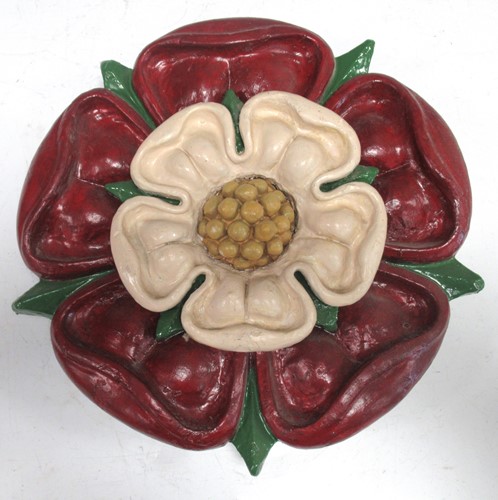 Lot 65 - A carved and painted Tudor rose, 31cm diameter
