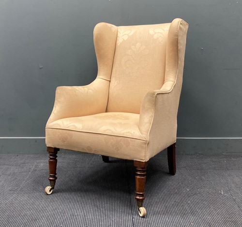 Lot 437 - A cream upholstered wingback armchair 108 x 70...
