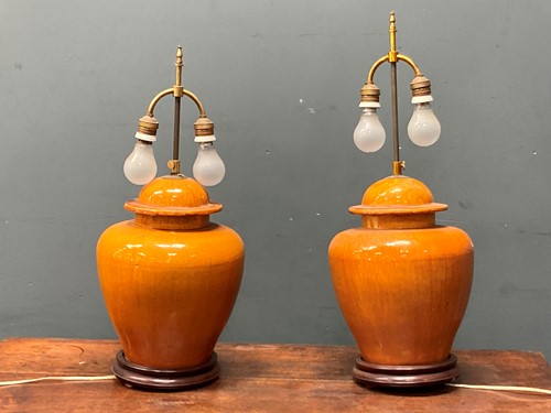 Lot 438 - A pair of orange glazed ceramic baluster vase...
