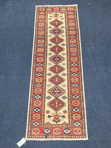 Lot 477 - A Russian Kazak runner 268 x 87cm