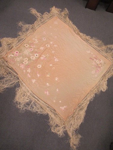 Lot 147 - A Chinese silk embroidered peach coloured shawl early 20th century