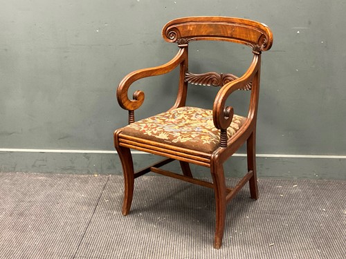 Lot 367 - A late Regency mahogany armchair on sabre legs