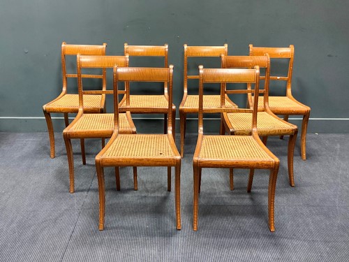 Lot 464 - A set of eight Regency satinwood chairs with...