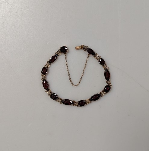 Lot 339 - A garnet set bracelet, stamped '9CT', weight...