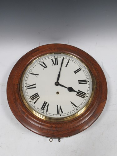 Lot 214 - An early 20th cenury oak cased circular wall...