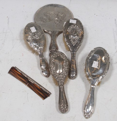 Lot 406 - A collection of four silver hairbrushes,...