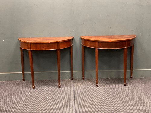 Lot 831 - A pair of George III style mahogany demi-lune...
