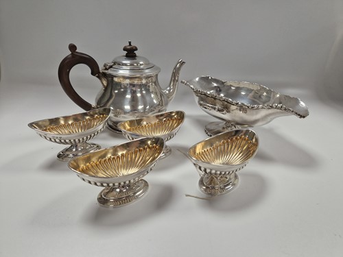 Lot 370 - A silver teapot, a set of four silver salts...