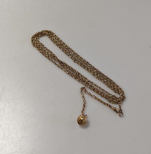 Lot 354 - A long guard chain, with a ball charm, tested...