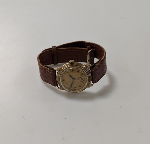 Lot 361 - An unsigned mid-century 9ct gold wristwatch on...