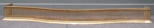 Lot 833 - A George III serpentine styled brass fender....
