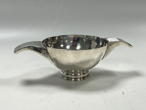 Lot 382 - A modern silver quaich, hammered finish,...