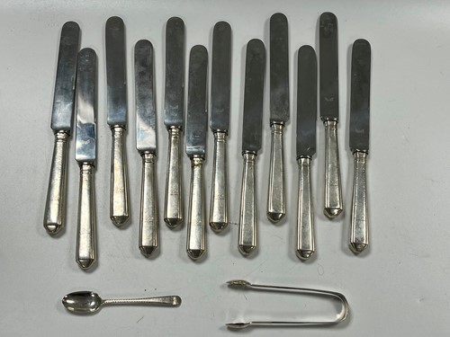Lot 379 - A set of 12 silver handled table knives with...