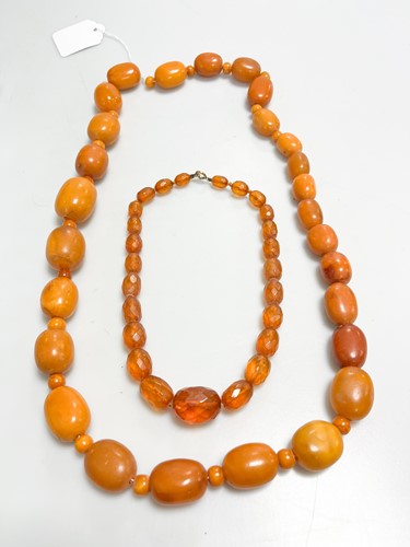Lot 342 - A string of amber beads, weight 176.8g,...