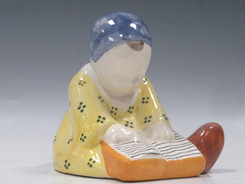 Lot 107 - A Quimper figure of a young girl reading by...