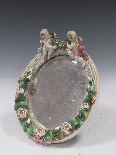 Lot 112 - A Dresden ceramic oval wall mirror, circa 1900,...