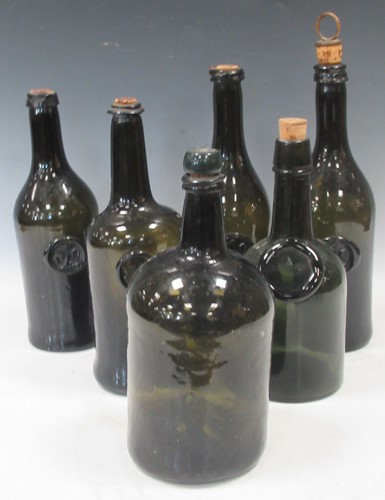 Lot 98 - Six dark green glass wine bottles with cork...