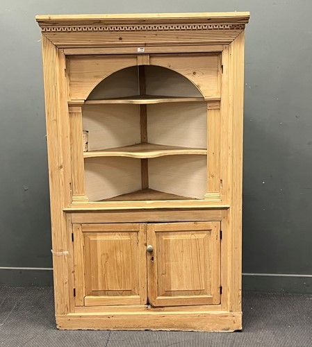 Lot 665 - An 18th century style pine corner cupboard...