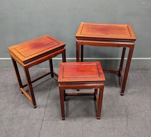 Lot 687 - A Chinese hardwood nest of four tables,...
