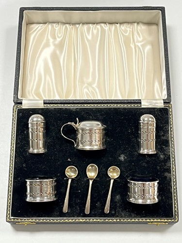 Lot 363 - A cased silver five-piece cruet set with blue...