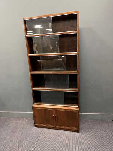 Lot 684 - Two 20th century stained oak sectional...