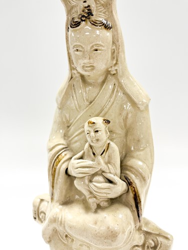 Lot 1 - A Chinese Cizhou figure of Guanyin with child, early 17th century