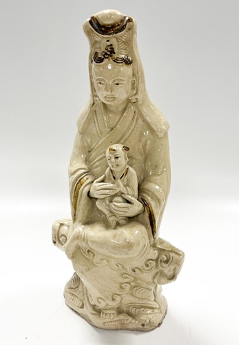 Lot 1 - A Chinese Cizhou figure of Guanyin with child, early 17th century