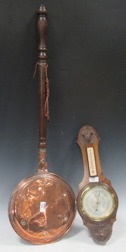 Lot 158 - An oak barometer 50cm high and a warming pan