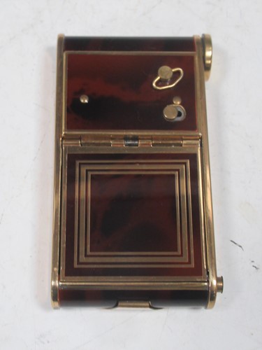 Lot 286 - A faux wooden and brass musical compact and...