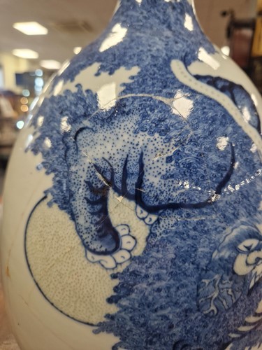 Lot 16 - A Chinese blue and copper-red porcelain Buddhist Lion bottle vase, Qing Dynasty, Kangxi Emperor circa 1700