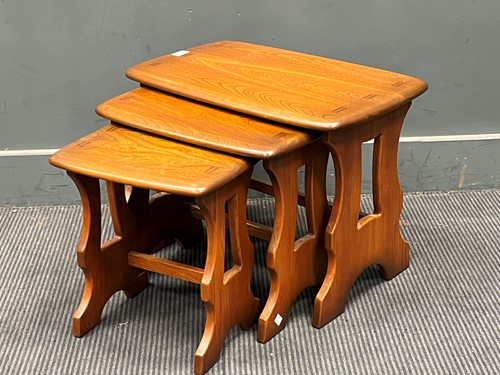 Lot 638 - A nest of three modern Ercol elm coffee tables....