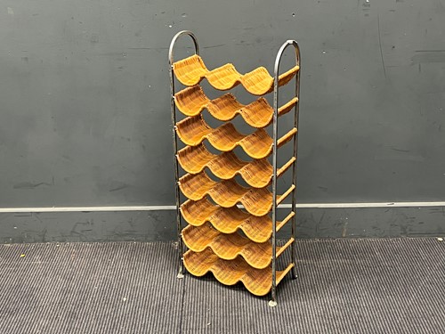 Lot 640 - A wicker and metal frame wine rack for 18...