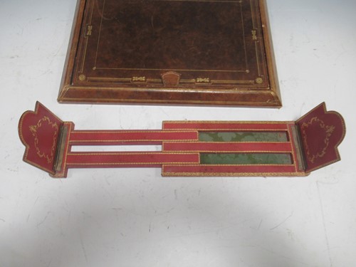 Lot 28 - An embossed leather desk blotter; book stand:...
