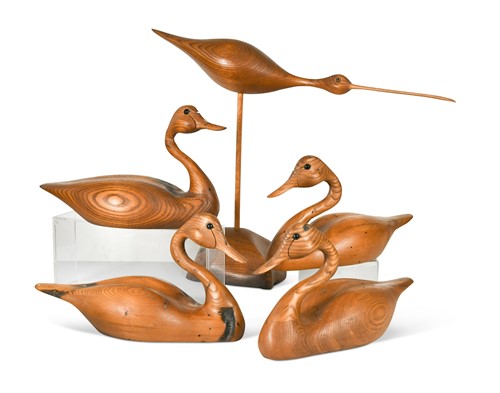 Lot 67 - Andy Pouch (Contemporary), four carved 'wormy chestnut' model swans