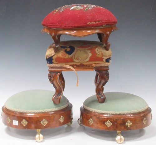 Lot 648 - A pair of Victorian walnut footstools on claw...