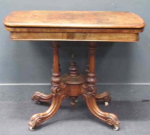Lot 600 - A Victorian walnut fold over card table, 74cm...