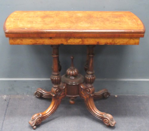 Lot 599 - A Victorian walnut fold over card table. 72cm...