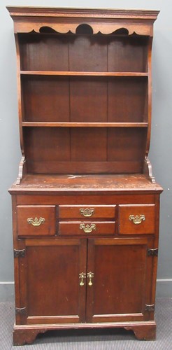 Lot 607 - A George III oak dresser base with later top...