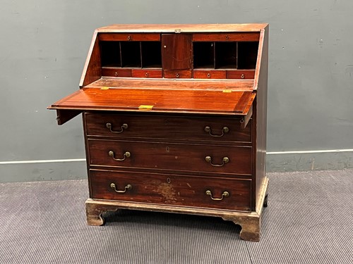 Lot 558 - A George III mahogany slope front bureau....
