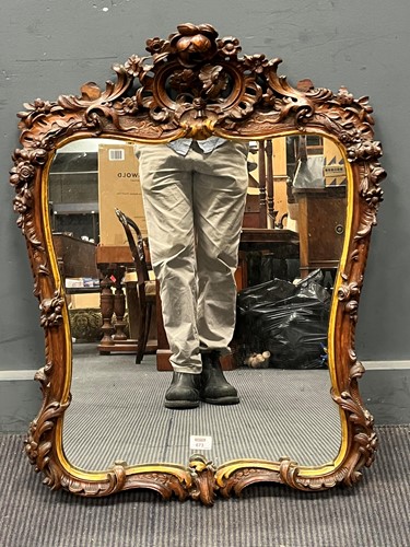 Lot 673 - A Victorian carved oak wall mirror, decorated...