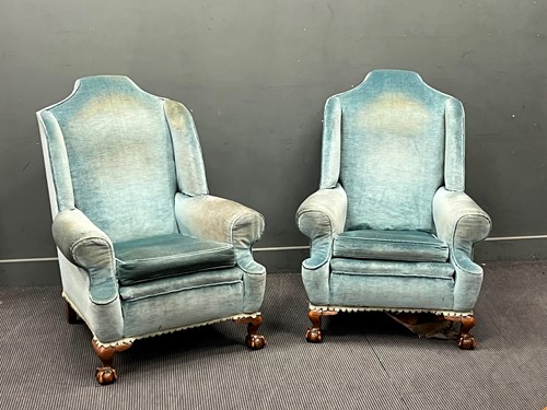 Lot 627 - A pair of George II style wing back armchairs...
