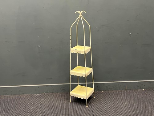 Lot 585 - A metal three-tier white painted whatnot, the...