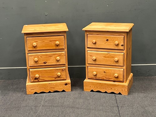 Lot 647 - A pair of pine three drawer bedside tables....