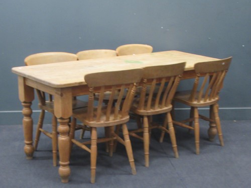 Lot 557 - A modern pine kitchen table on turned legs....