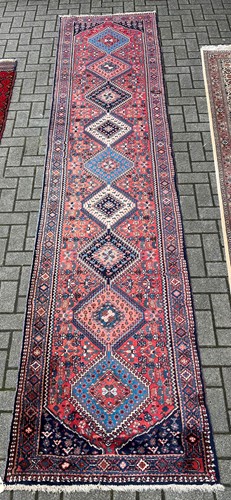 Lot 706 - A Persian wool runner with nine central...
