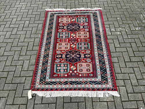 Lot 712 - A Kazak wool rug with alternate eau de nil...